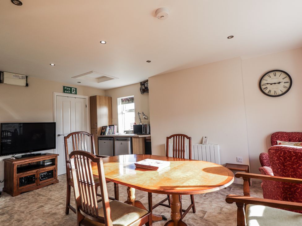 A dining room with a table and chairs at 15 New Shawbost in Shawbost