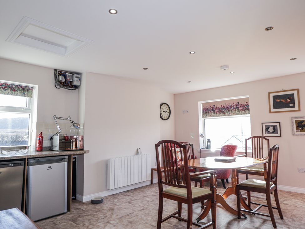 A kitchen with a table and chairs at 15 New Shawbost in Shawbost
