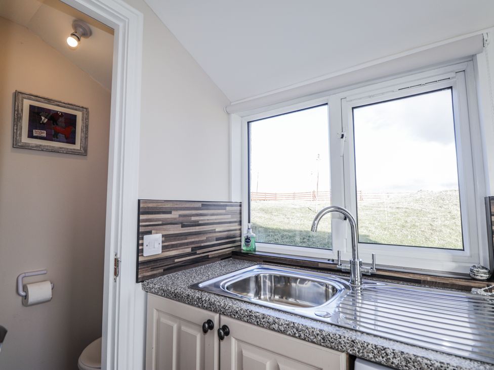 A bathroom with a sink and window at 15 New Shawbost in Shawbost
