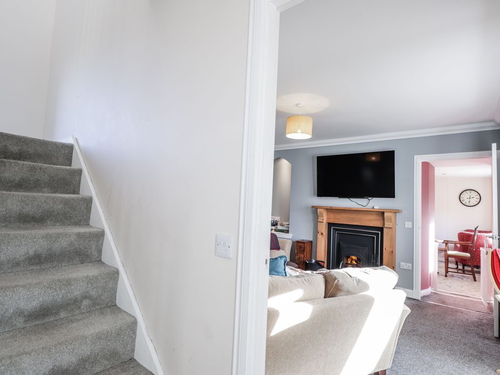 A living room with a television and a fireplace at 15 New Shawbost in Shawbost