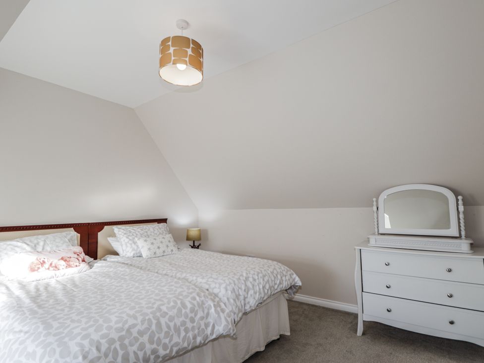 A bedroom with a bed and dresser at 15 New Shawbost in Shawbost