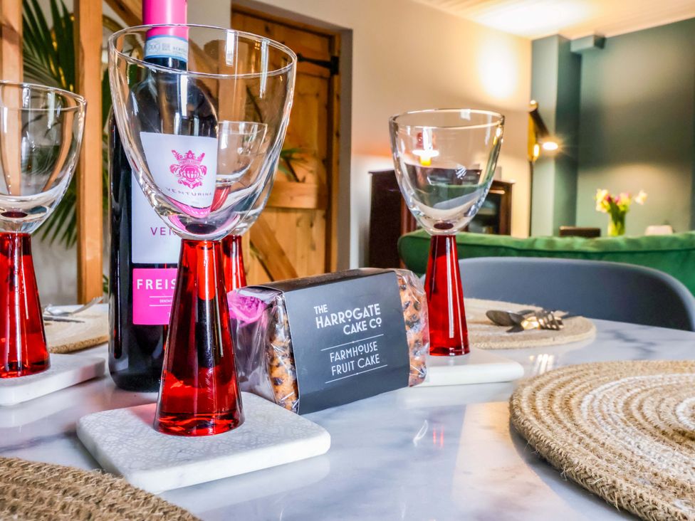 A dining table with wine glasses and a fruit cake at The Green in Sawley near Ripon