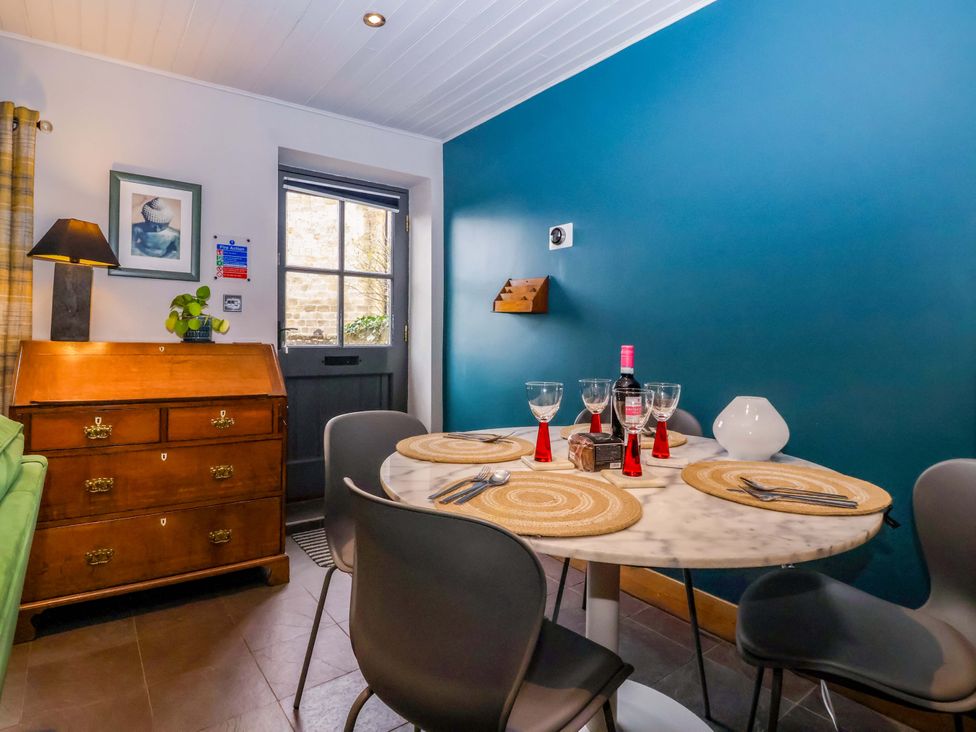 A dining room with a table and chairs at The Green in Sawley near Ripon