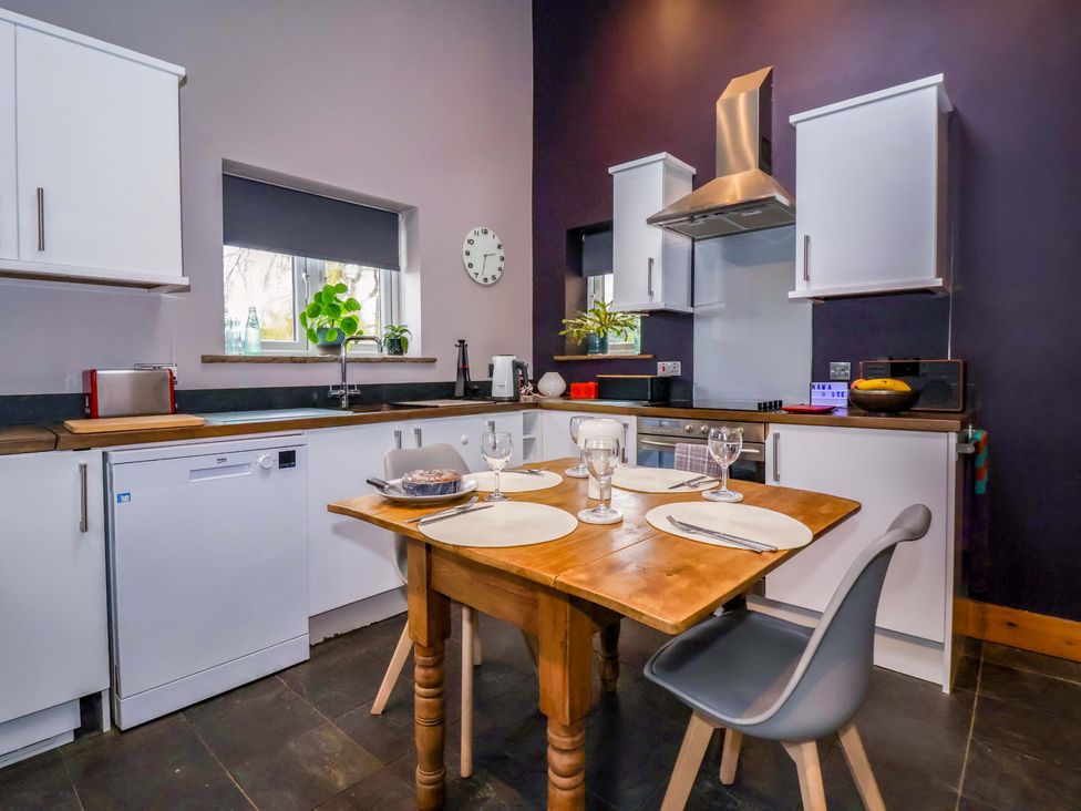 A kitchen with a dining table and chairs at The Green in Sawley near Ripon