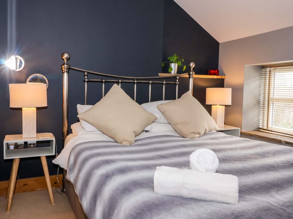 A bedroom with a bed and bedside tables at The Green in Sawley near Ripon