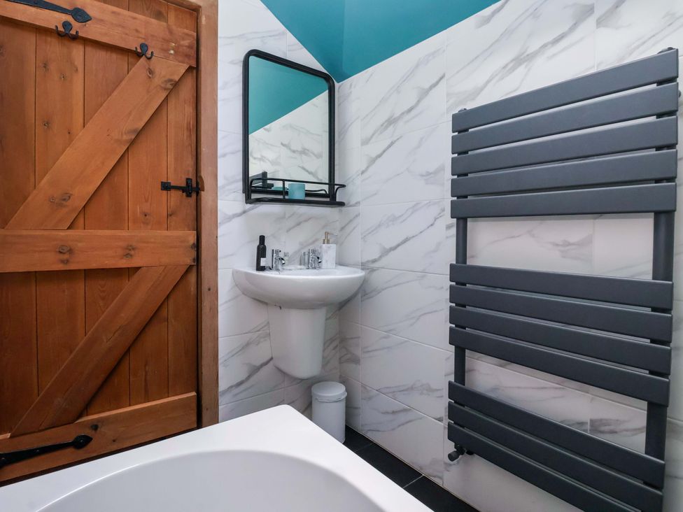 A bathroom with a wash basin and a towel rail at The Green in Sawley near Ripon