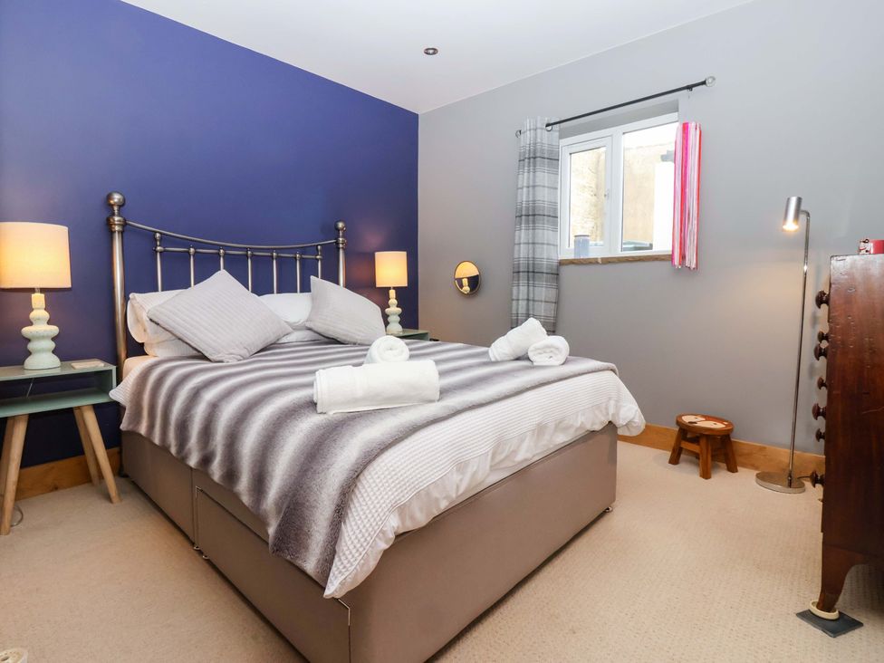 A bedroom with a bed and lamps at The Green near Ripon