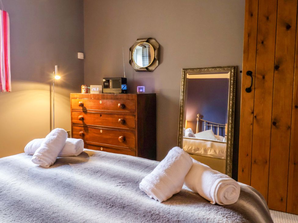 A bedroom with a bed and dresser at The Green in Sawley near Ripon