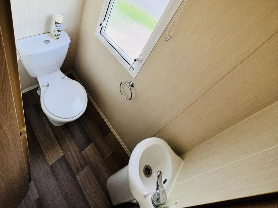 A bathroom with a toilet and sink at The Wild’s Waterside Haven in Cleethorpes