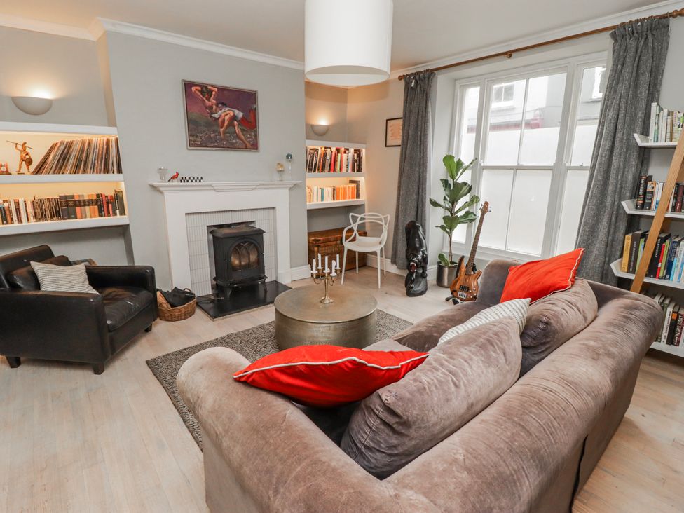 A living room with a fireplace and bookshelves at The Secret Garden in Narberth