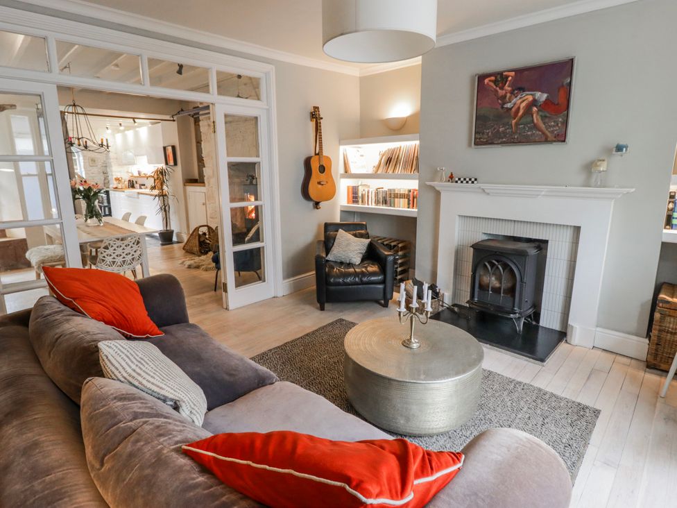 A living room with a sofa and fireplace at The Secret Garden in Narberth