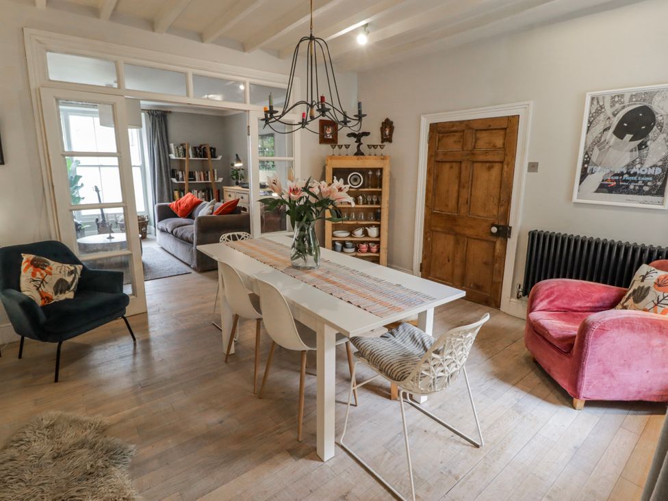 A dining room with a table and chairs at The Secret Garden in Narberth