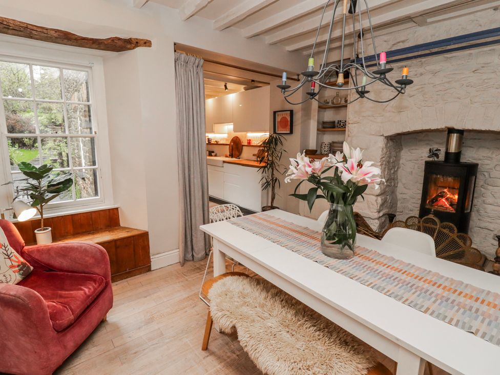 A dining room with a table and chairs at The Secret Garden in Narberth