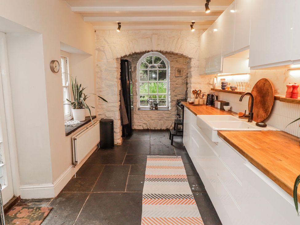 A kitchen with a window and countertop at The Secret Garden in Narberth