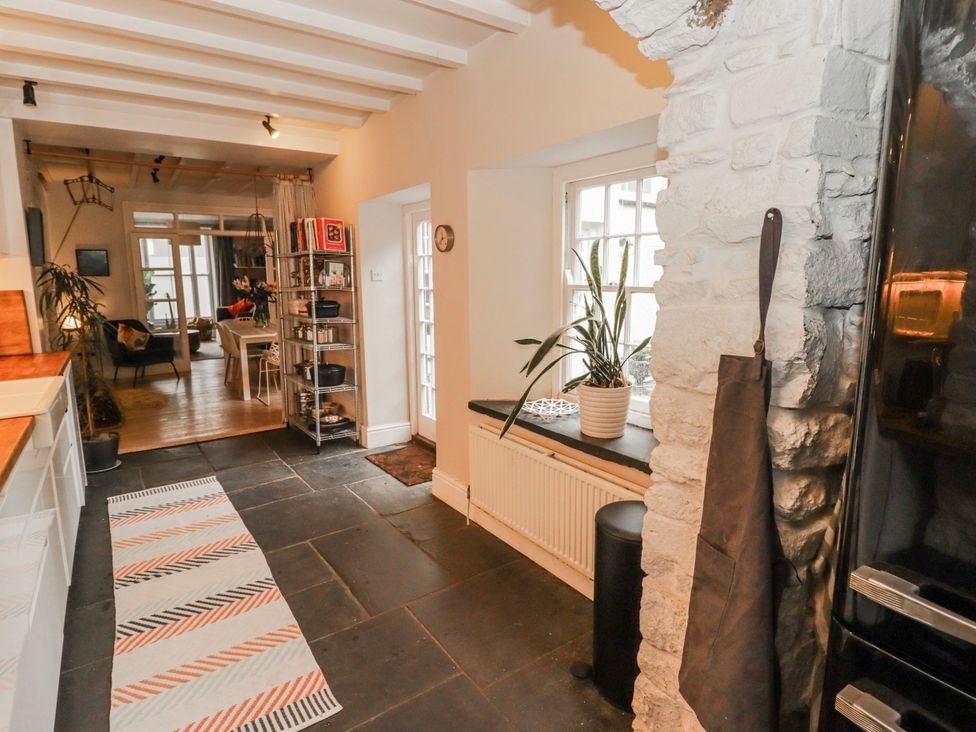 A kitchen with shelves and a plant at The Secret Garden in Narberth