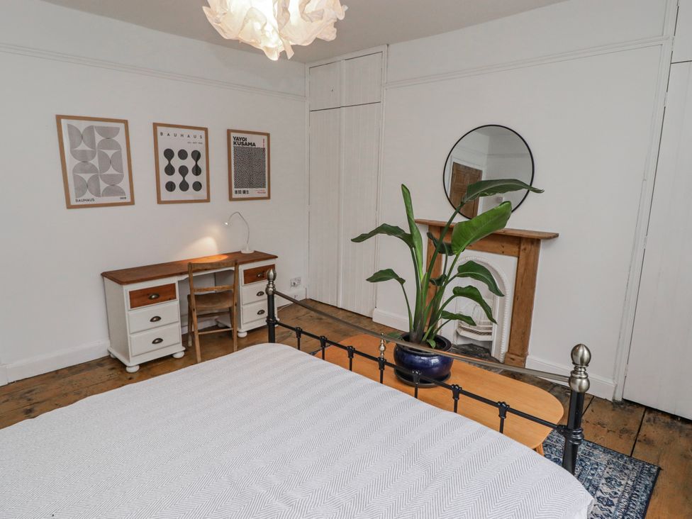 A bedroom with a bed and desk at The Secret Garden in Narberth