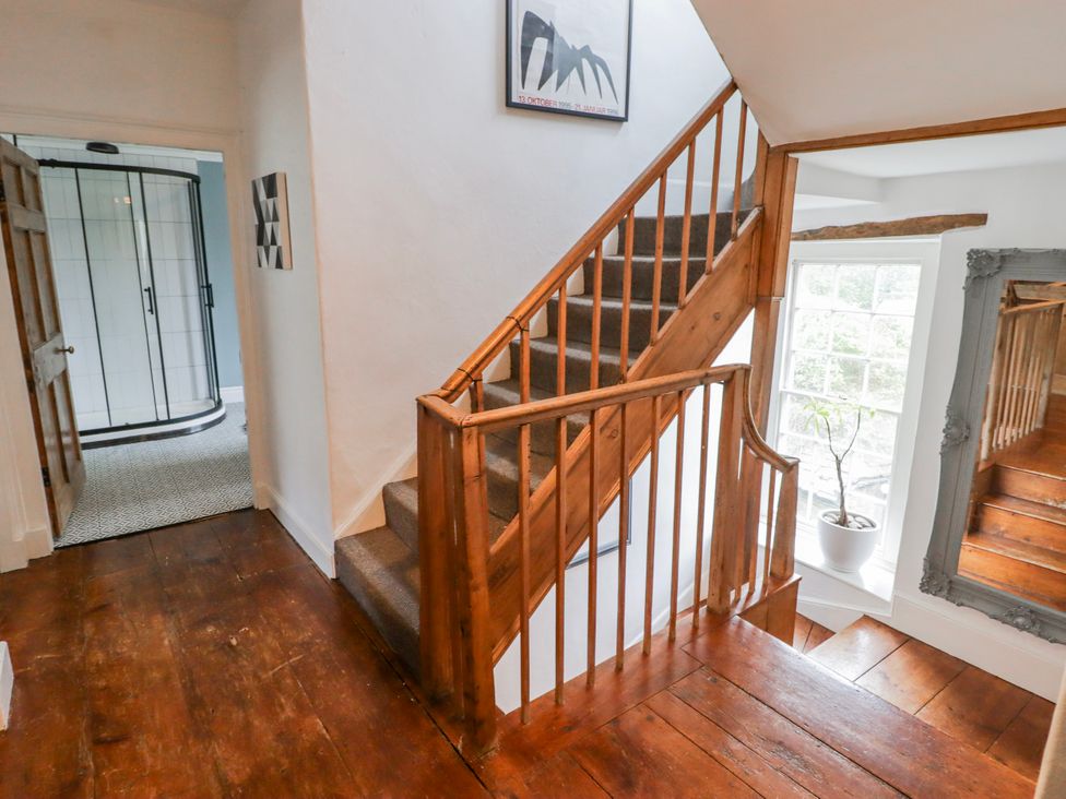 A staircase and door in the hallway at The Secret Garden in Narberth