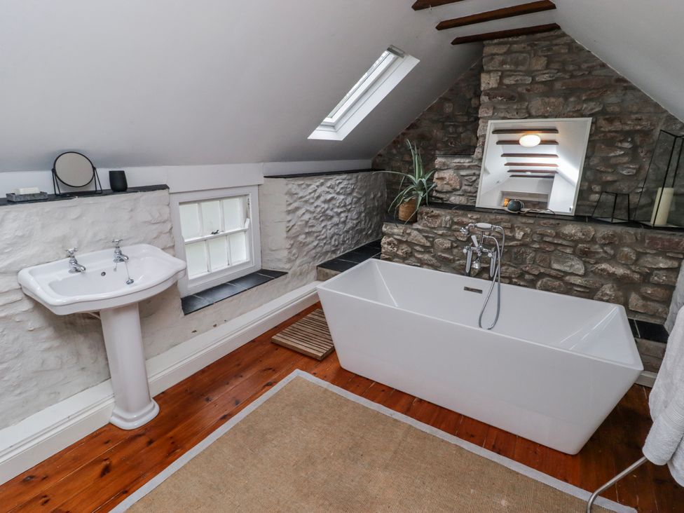 A bathroom with a bathtub and sink at The Secret Garden in Narberth