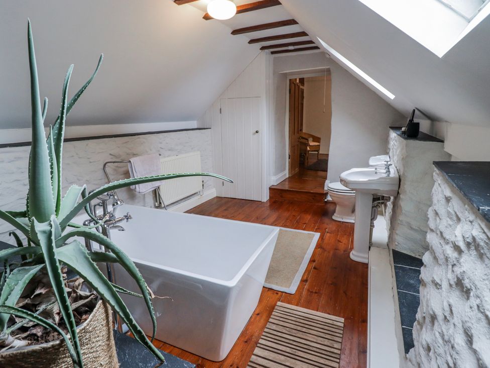 A bathroom with a bathtub and toilet at The Secret Garden in Narberth