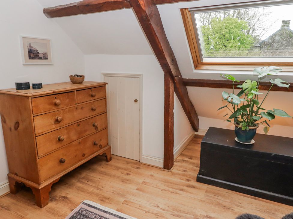 A bedroom with a dresser and a small door at The Secret Garden in Narberth