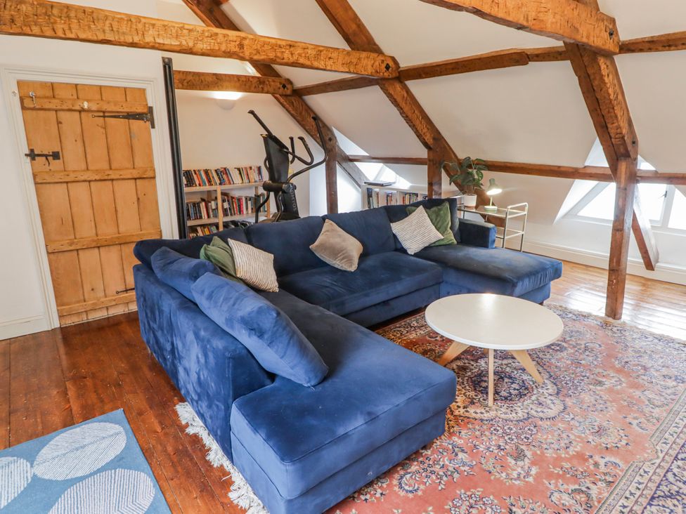 A living room with a blue sofa and coffee table at The Secret Garden in Narberth