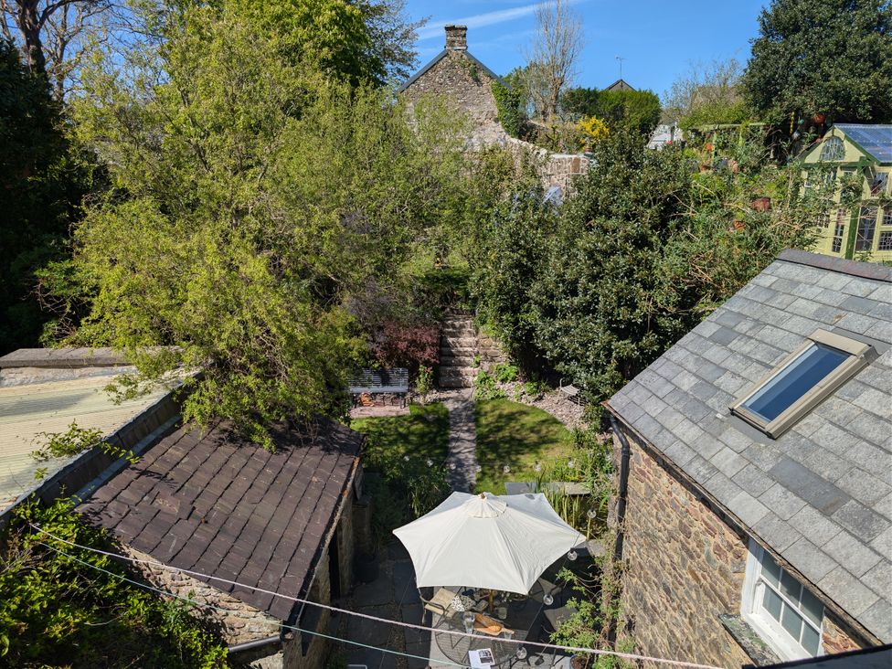 A garden with a pathway and outdoor seating area at The Secret Garden in Narberth