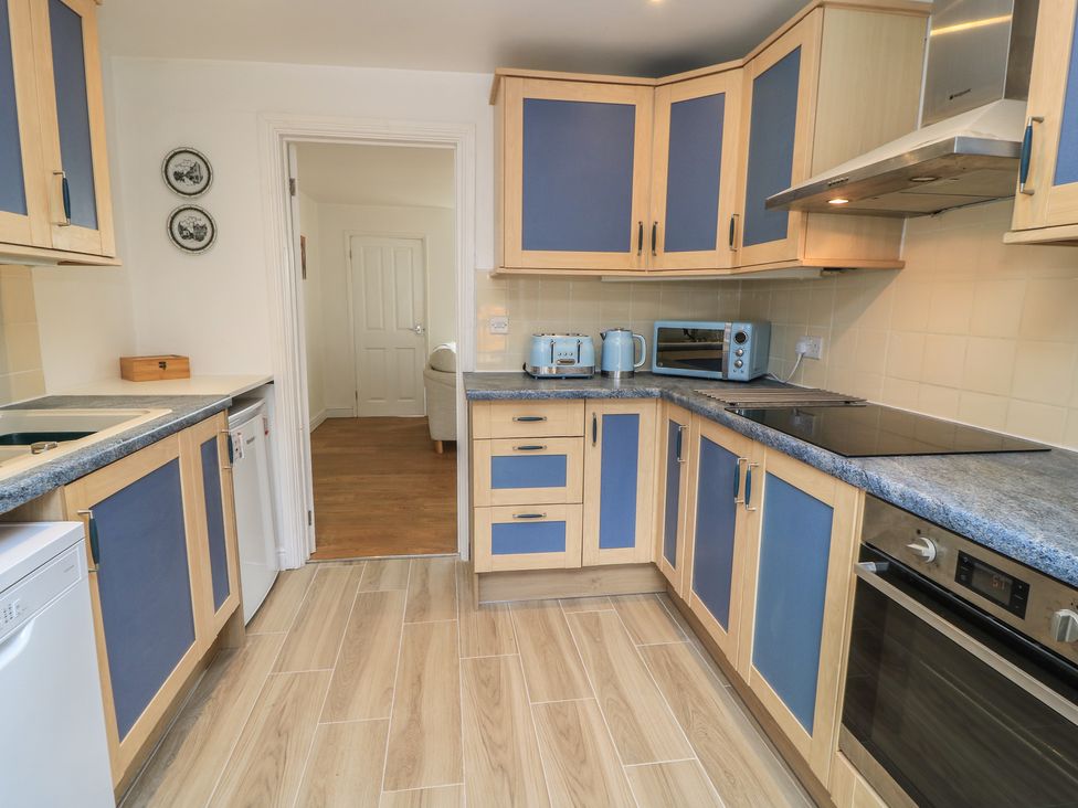 A kitchen with cabinets and appliances at 11 Berry Close in Painswick