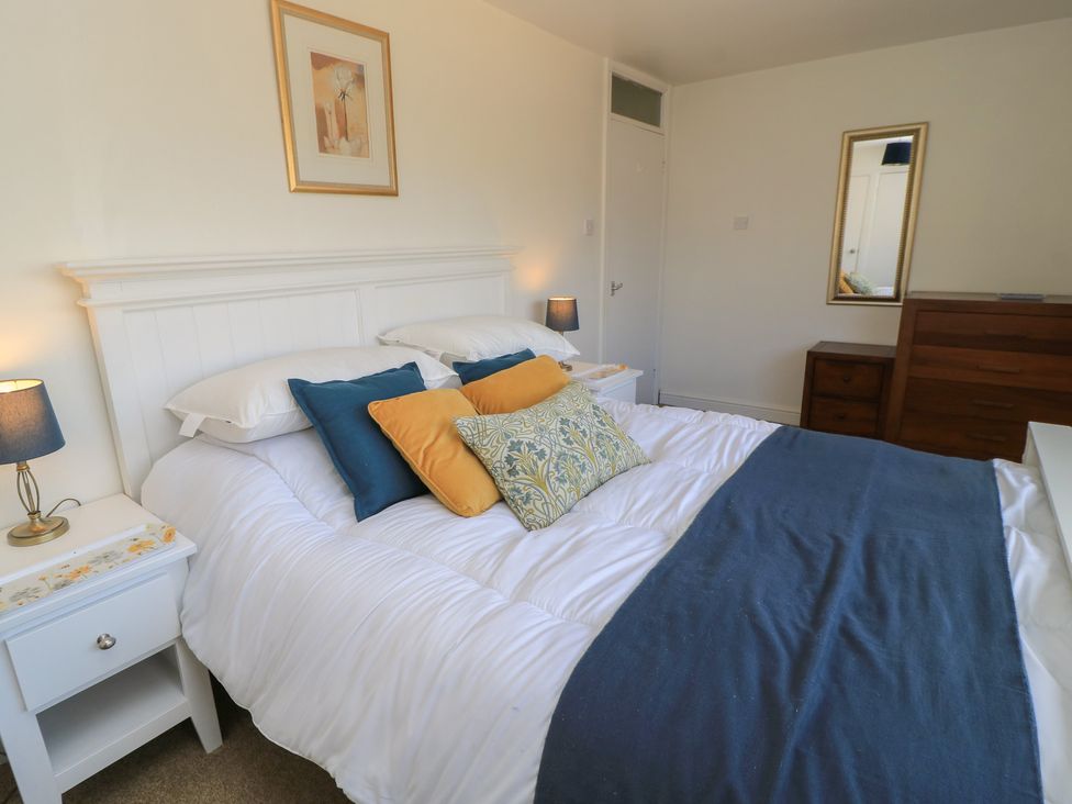 A bedroom with a bed and furniture at 11 Berry Close in Painswick