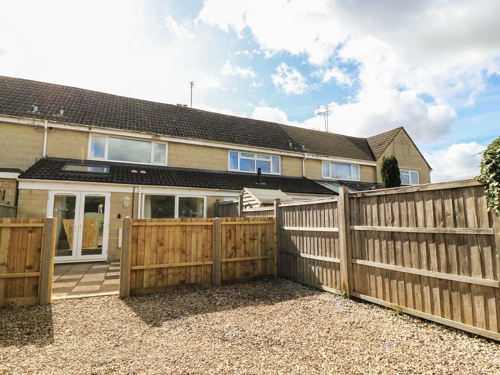 A backyard view with a gravel area and wooden fencing at 11 Berry Close in Painswick