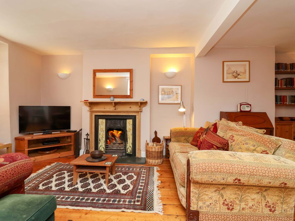 A living room with a fireplace and sofa at 12 Heathfield Terrace 