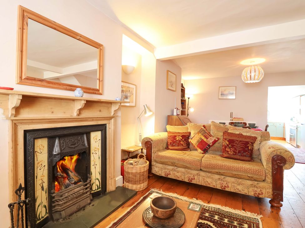 A living room with a fireplace and sofa at 12 Heathfield Terrace