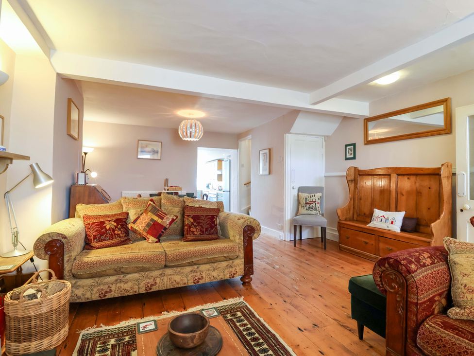 A living room with a sofa, armchair, and coffee table at 12 Heathfield Terrace
