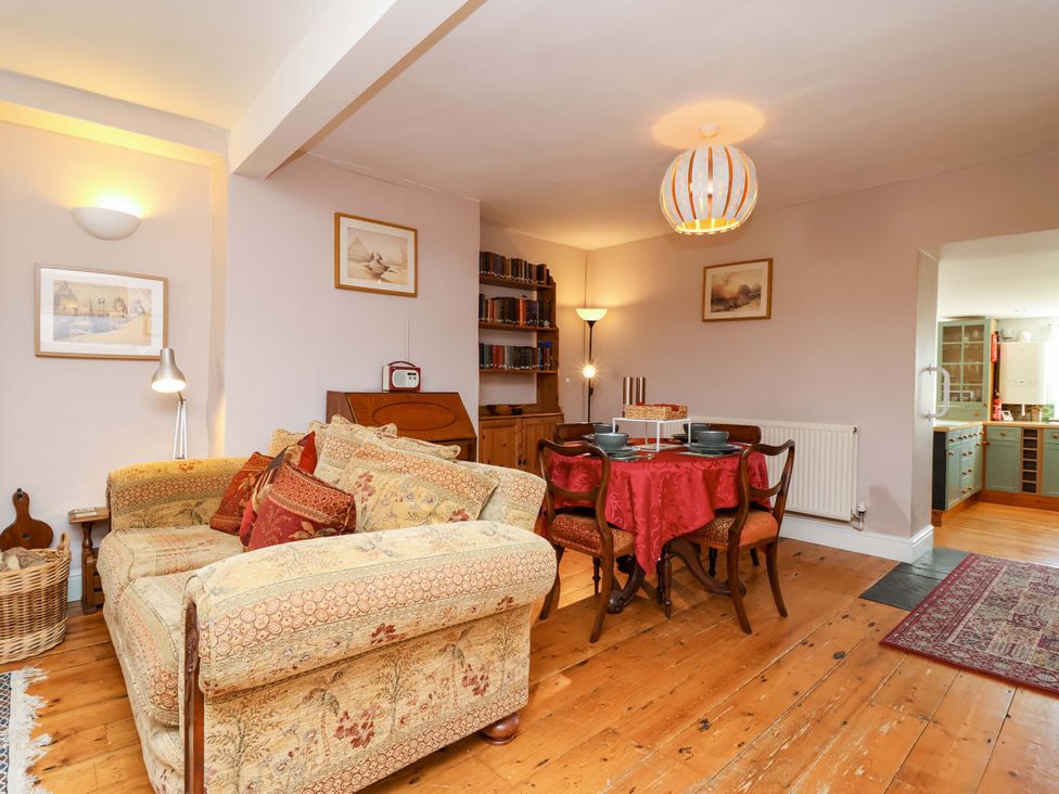 A dining room with a sofa and table at 12 Heathfield Terrace