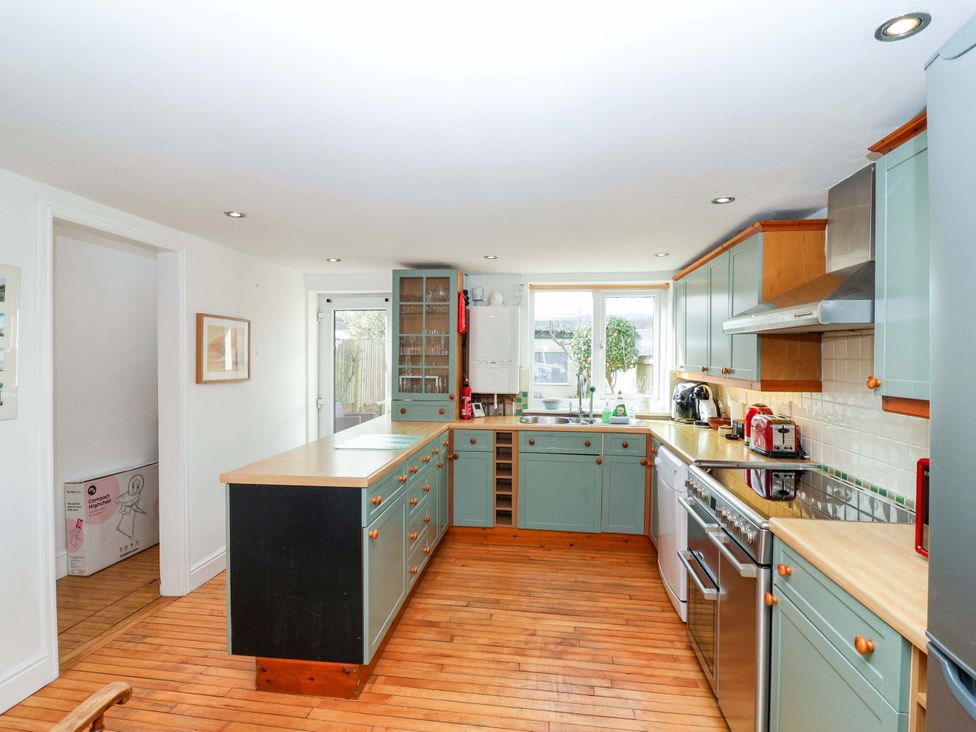 A kitchen with cabinets and appliances at 12 Heathfield Terrace
