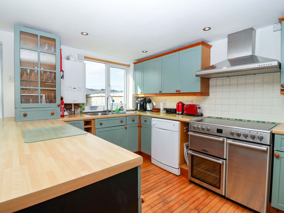 A kitchen with cabinets and appliances at 12 Heathfield Terrace
