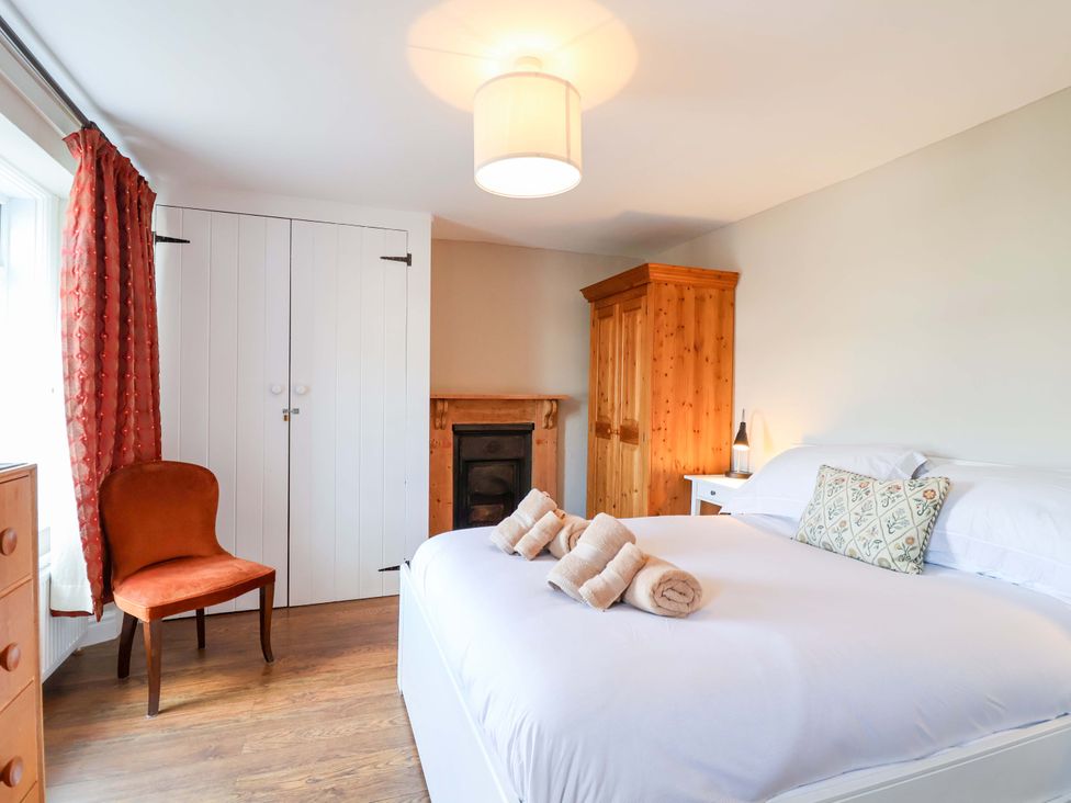 A bedroom with a bed and wardrobe at 12 Heathfield Terrace