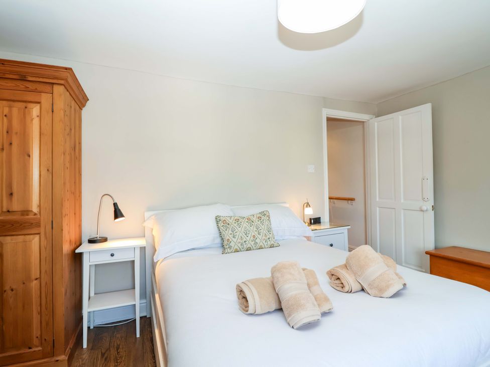 A bedroom with a bed and towels on top at 12 Heathfield Terrace