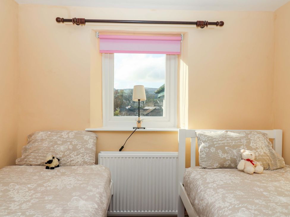 A bedroom with two beds and a window at 12 Heathfield Terrace