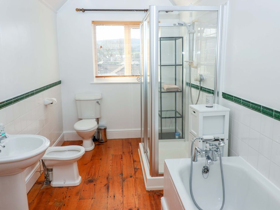 A bathroom with a shower, bathtub, sink, and toilet at 12 Heathfield Terrace