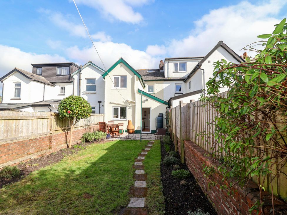 A garden with a pathway and a house at 12 Heathfield Terrace