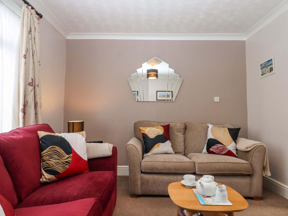 A living room with a sofa and coffee table at 16 Elmbank Gardens in Paignton