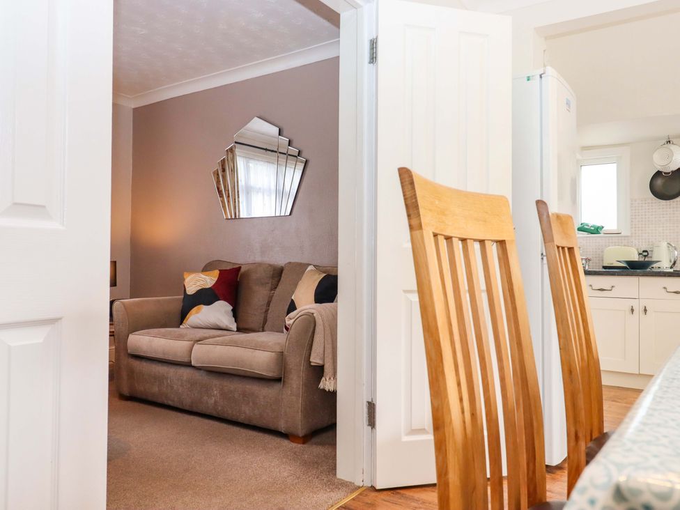 A dining room with a view into a living room at 16 Elmbank Gardens Paignton