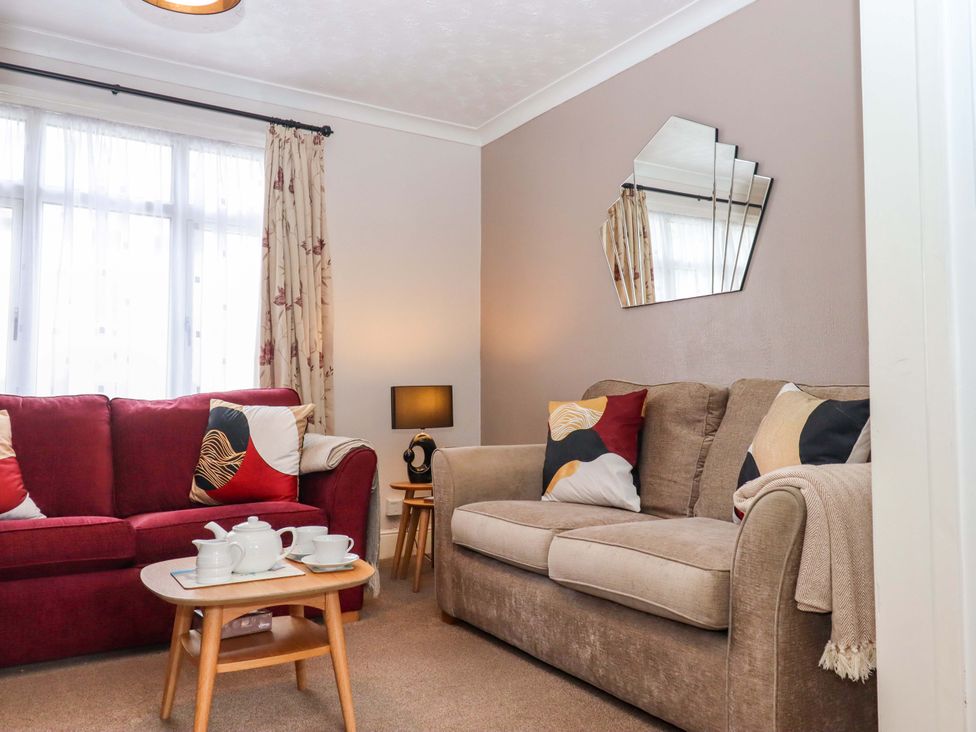 A living room with sofas and a coffee table at 16 Elmbank Gardens in Paignton