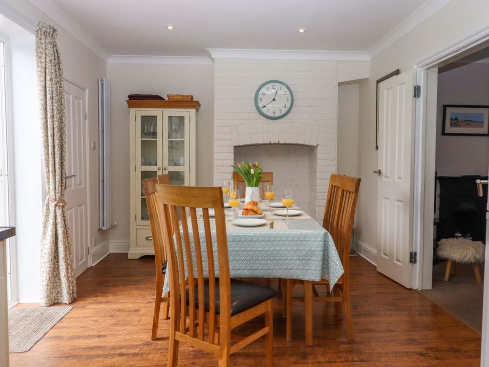A dining room with a table set for breakfast at 16 Elmbank Gardens Paignton