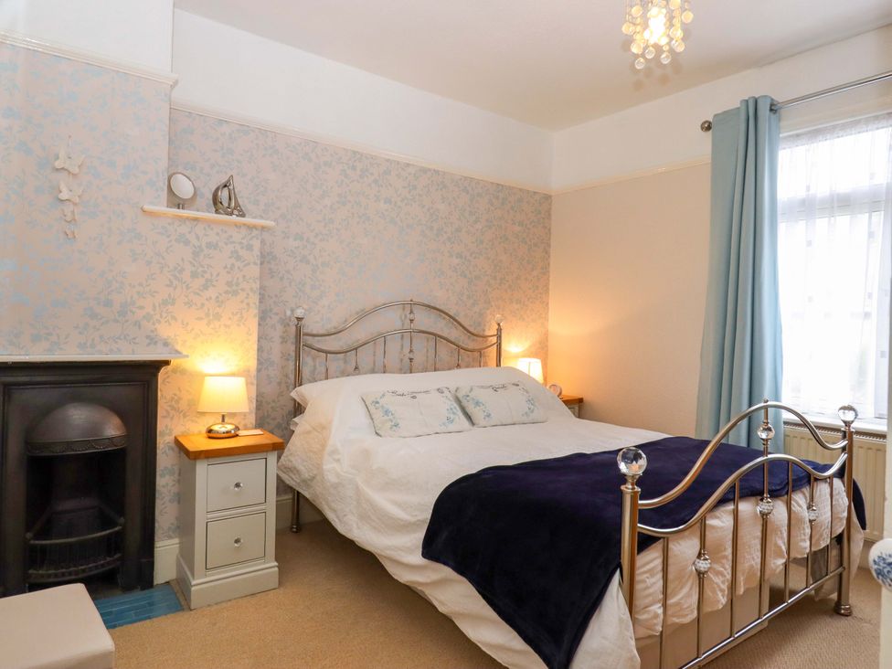 A bedroom with a bed and nightstands at 16 Elmbank Gardens in Paignton