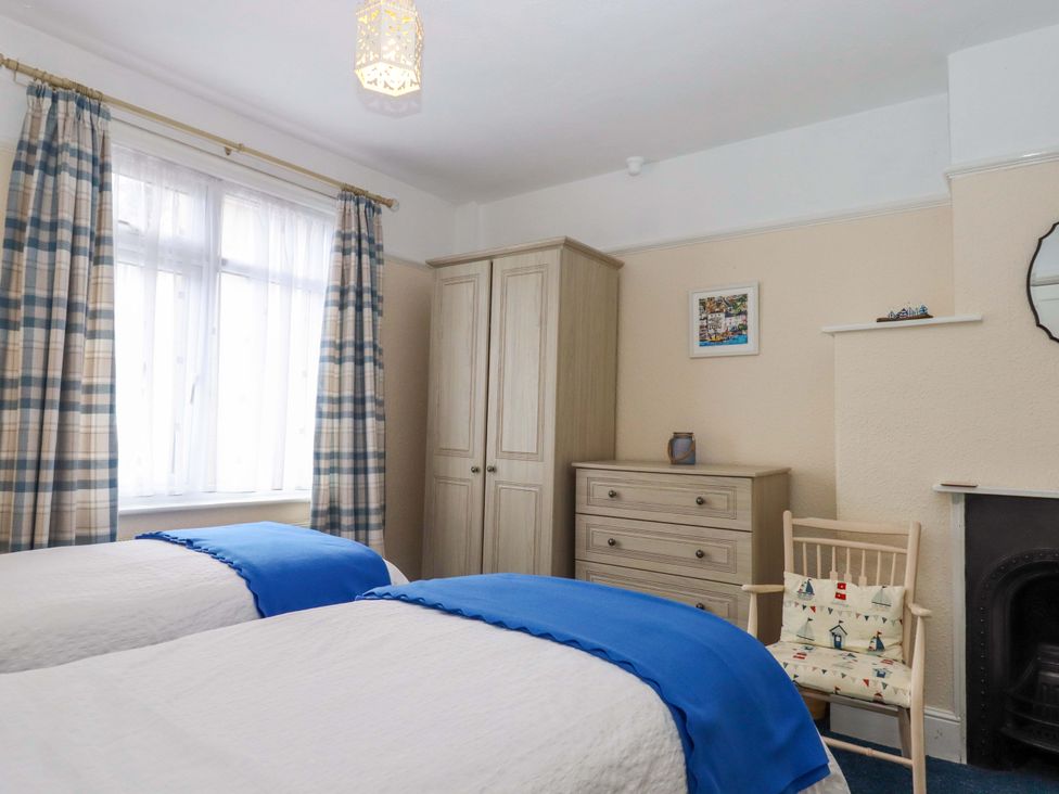 A bedroom with two beds and furniture at 16 Elmbank Gardens in Paignton