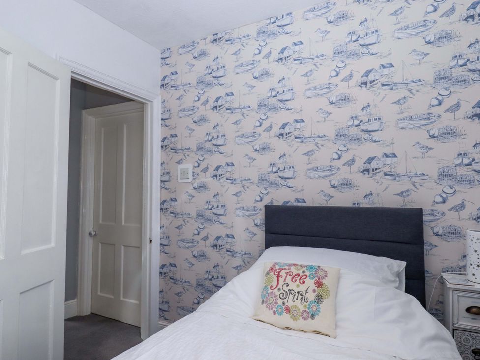 A bedroom with a bed and pillow at 16 Elmbank Gardens Paignton