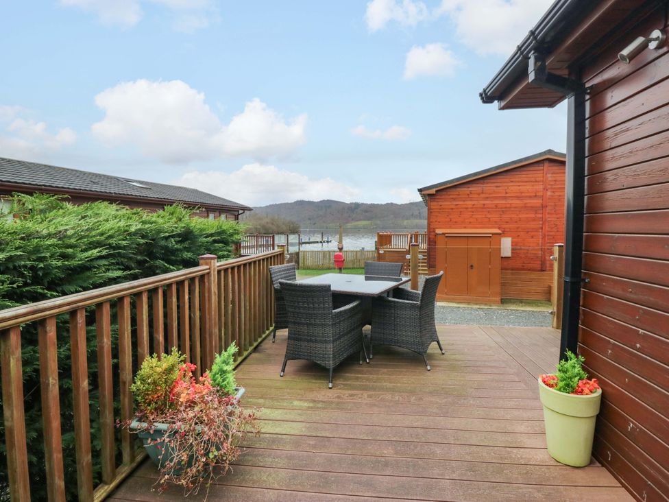 An outdoor space with a table and chairs at Waters Edge Lodge Windermere