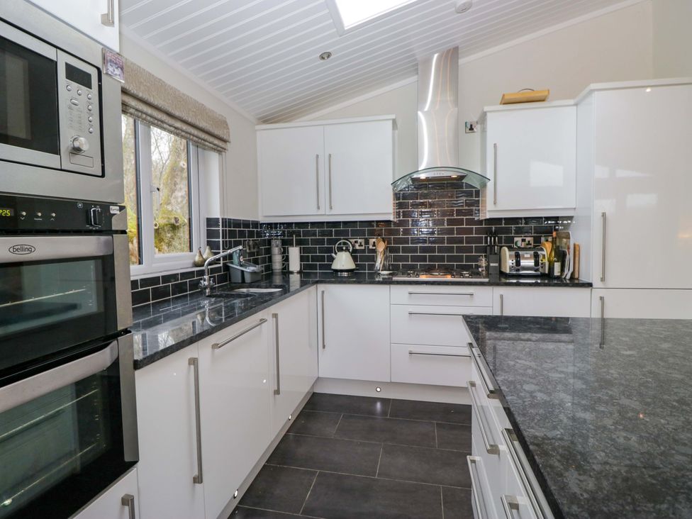 A kitchen with modern appliances at Waters Edge Lodge Windermere
