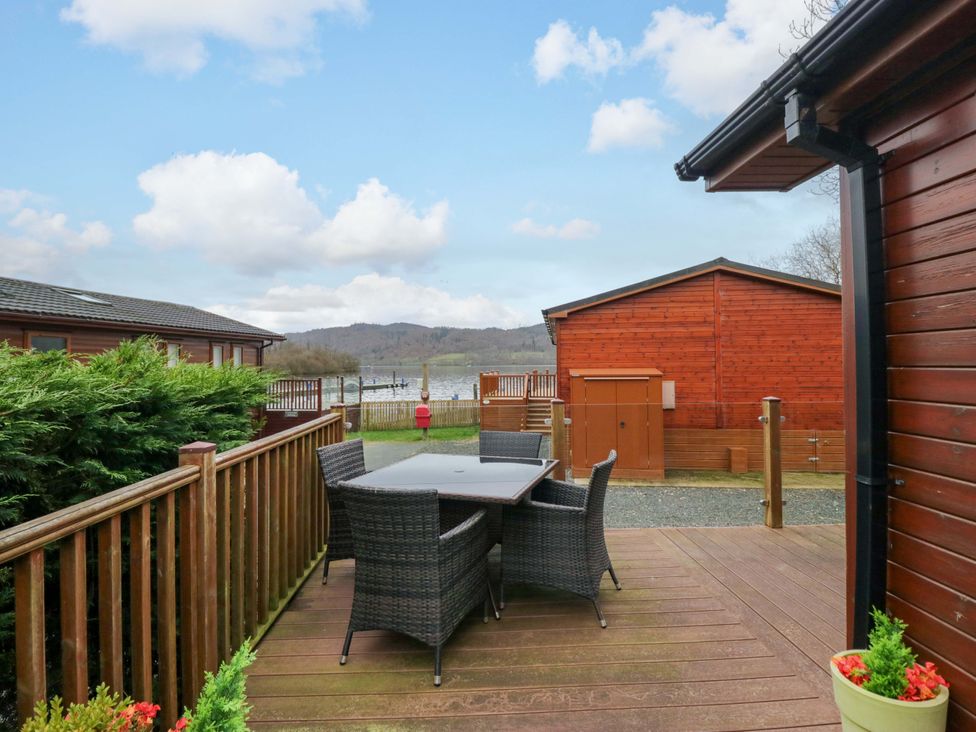 An outdoor dining area with a table and chairs at Waters Edge Lodge in Windermere